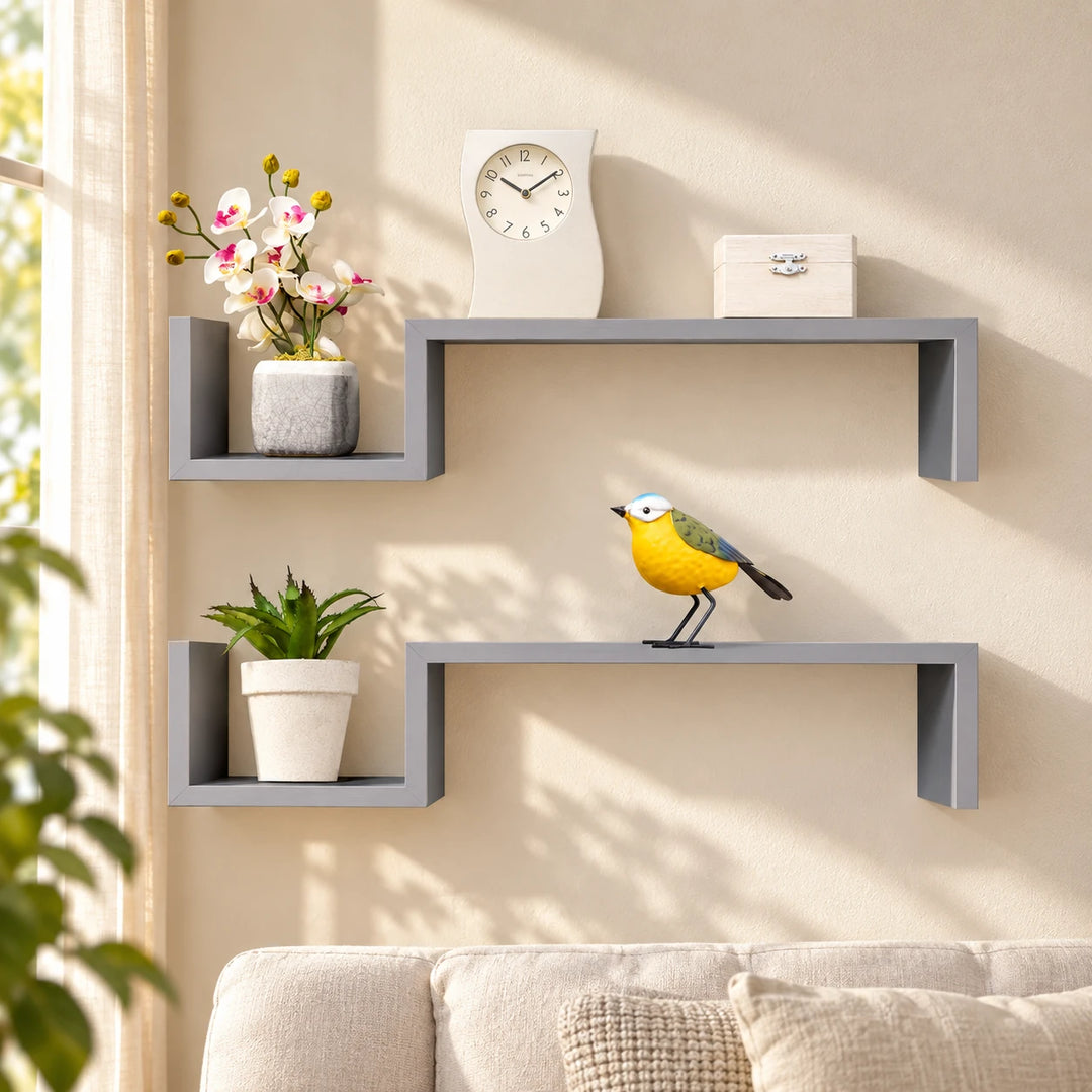 Two grey stepped floating shelves in a sunlit living room
