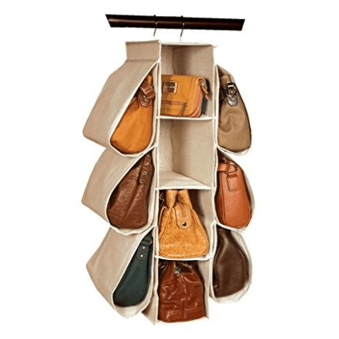 Beige hanging purse organizer on a closet rod holding ten handbags