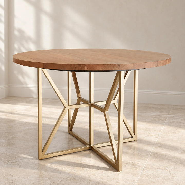 Hayes round wood top dining table with gold geometric base in natural light