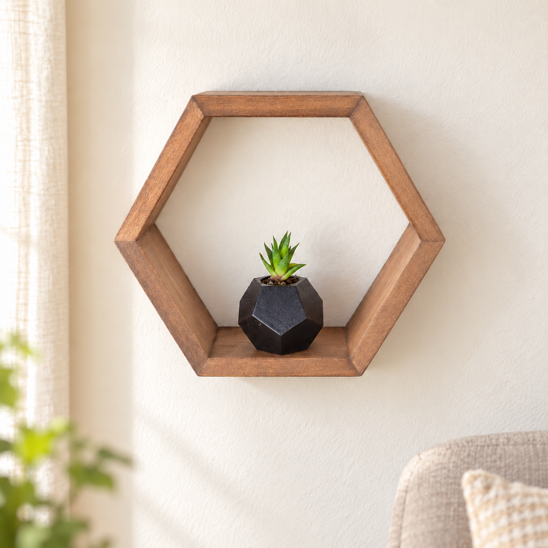 Single natural brown hexagonal wooden wall shelf with a small succulent in soft daylight