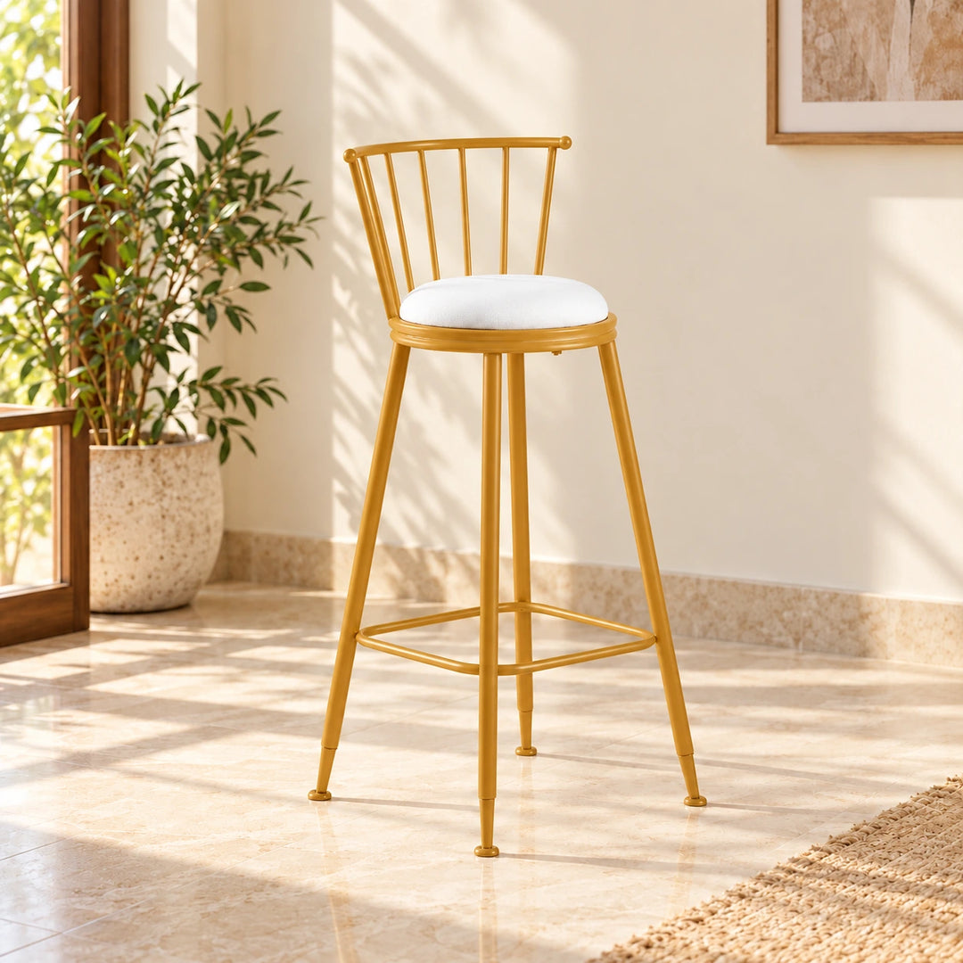 One Jasper stool with white seat and Akil Gold powder-coated frame in natural daylight