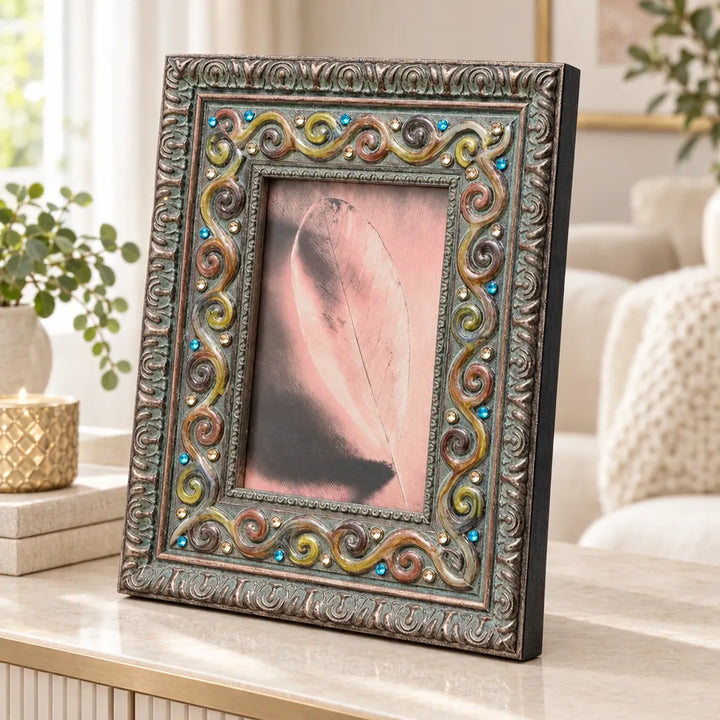 Antique silver photo frame with colourful scroll border holding pink photo