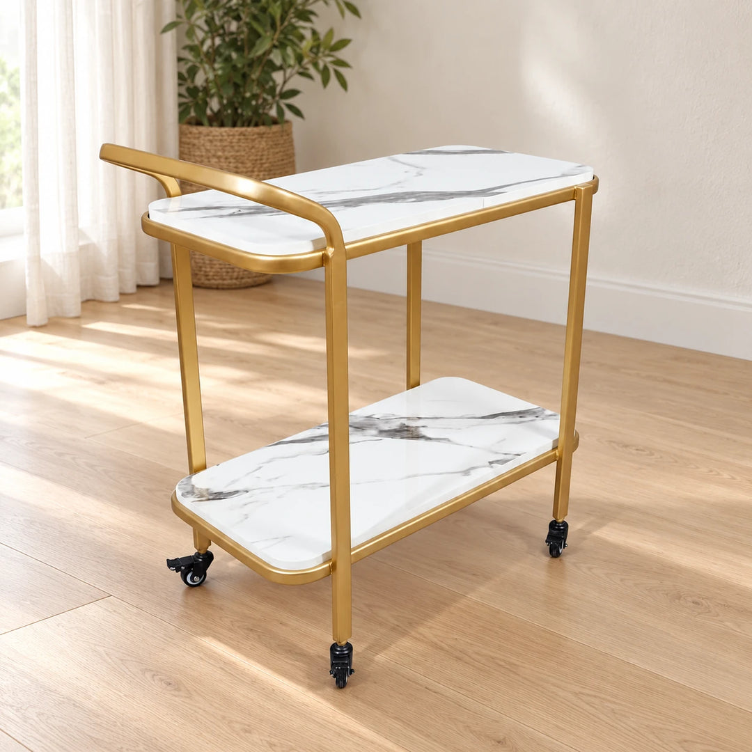 Gold two-tier serving trolley with white marble-pattern shelves in a sunlit room