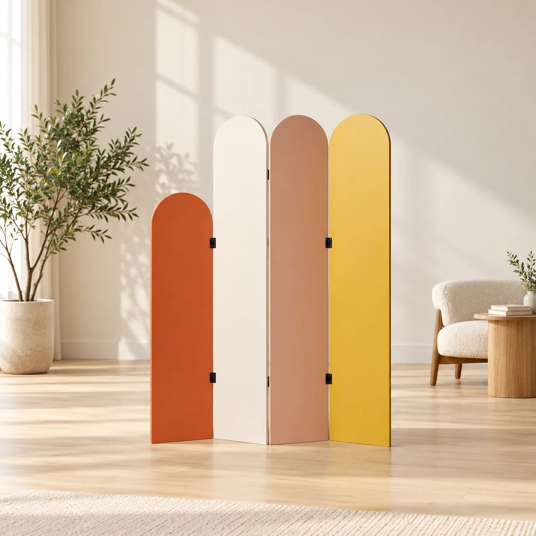 Four-panel arched room divider in terracotta ivory muted pink and mustard in a styled room with a natural plant