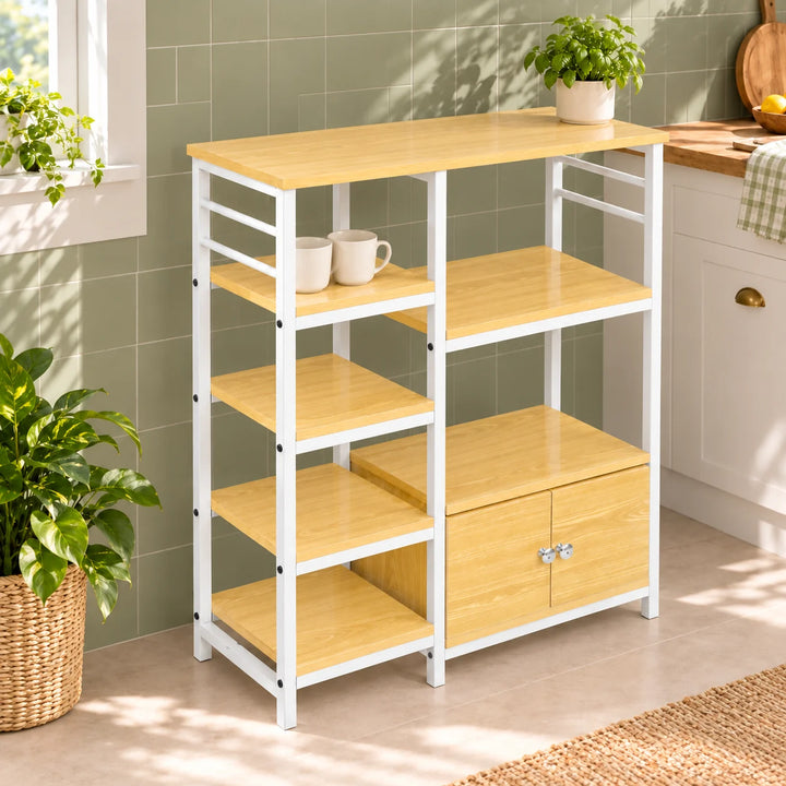 White frame kitchen bakers rack with pale shelves and cabinet styled with basil and two cups