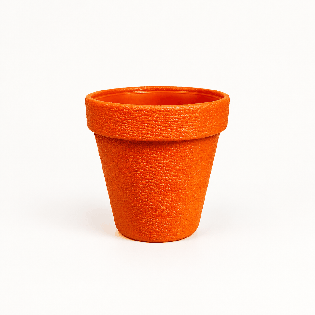 Large orange textured planter pot, empty, on plain white background