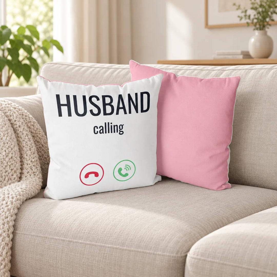 Loomiee Husband Calling printed cushion cover and its baby pink companion, shown as the original two-cover pair in a living room