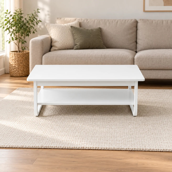 Full white rectangular two-tier tea table with curved white end frames in a softly lit neutral living room