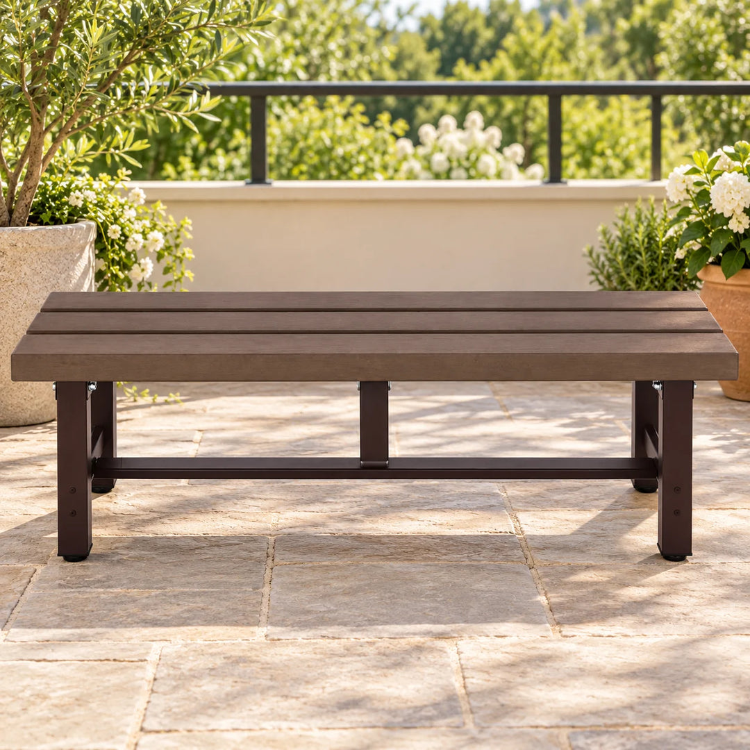 Mendler dark brown backless bench on a terrace with natural plants
