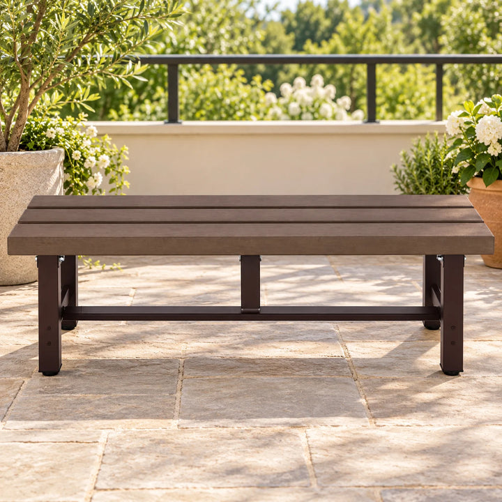 Mendler dark brown backless bench on a terrace with natural plants