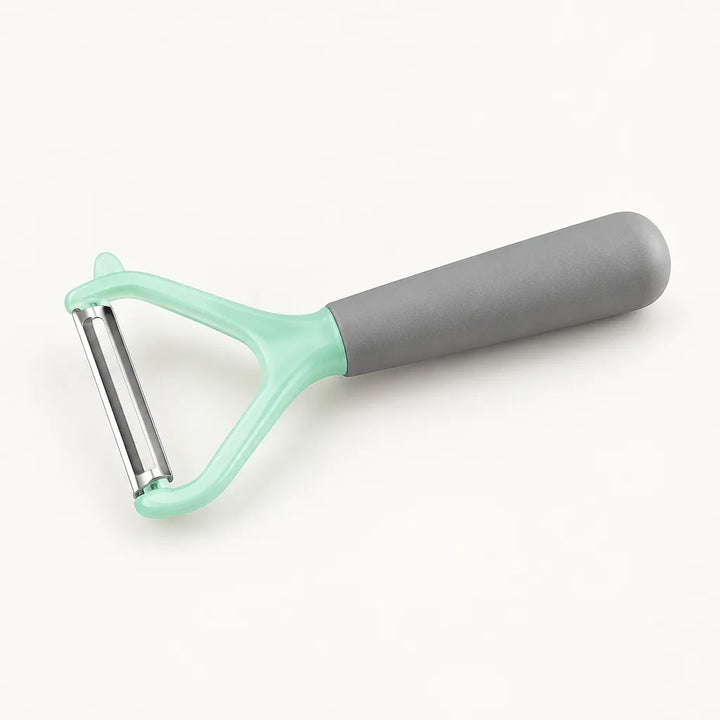 Vegetable peeler slicer with grey handle and mint green head on white background