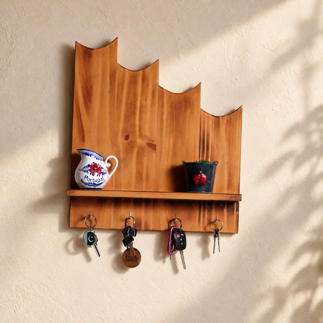 Mounted Owl wooden key organizer with four hooks and its existing shelf accessories on a softly lit entryway wall