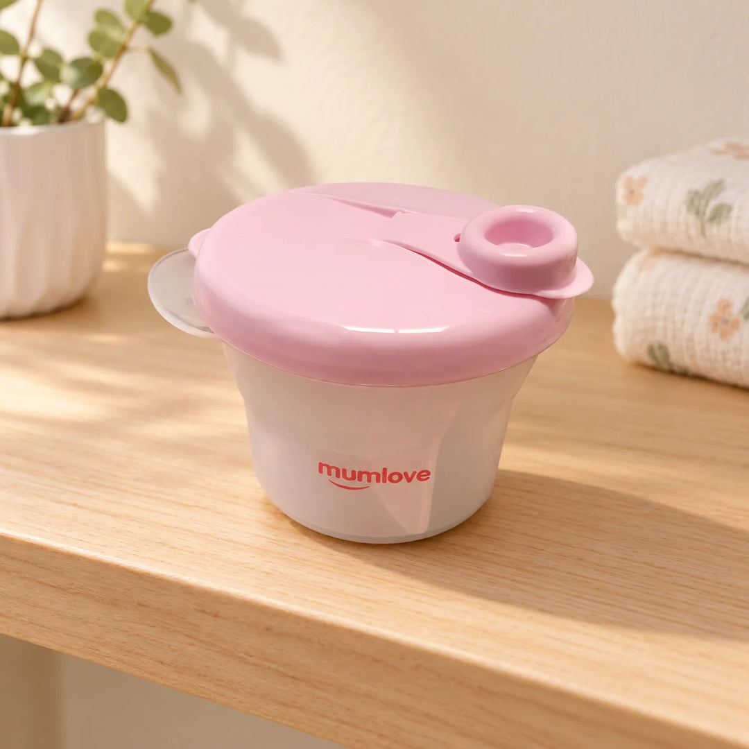 Closed pink Mumlove powder-puff container in natural daylight
