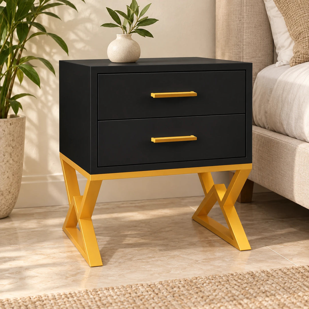 Nugatory black two-drawer bedside table with gold powder-coated crossed legs in a daylight bedroom