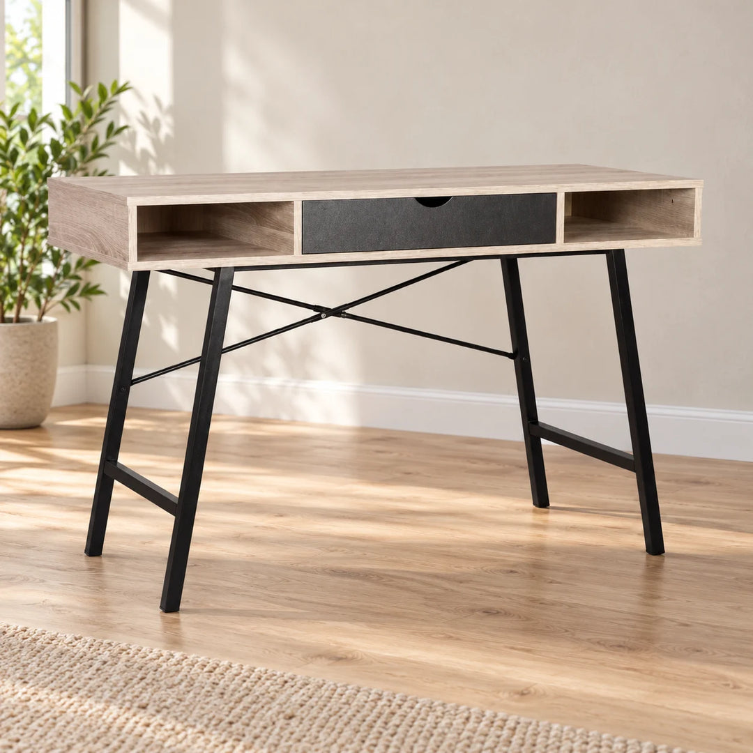 Light wood Oldcastle desk with black legs, a charcoal centre drawer and two open cubbies in a naturally lit home study