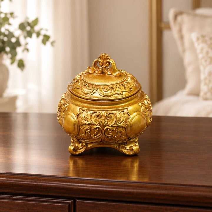 Gold carved decorative storage box with ornate domed lid and footed base in living room