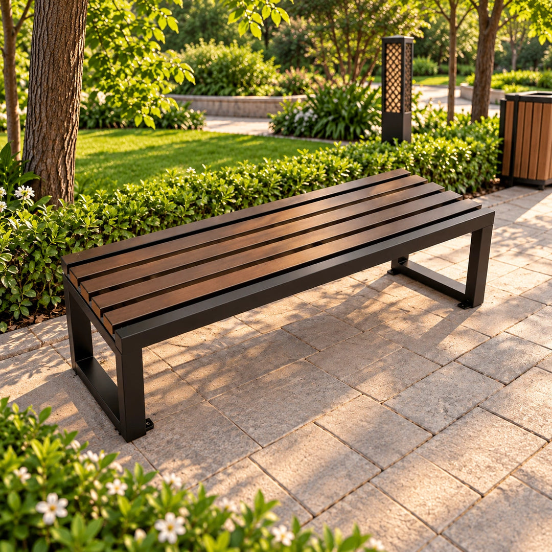 Brown slatted garden bench with dark rectangular metal legs on stone paving