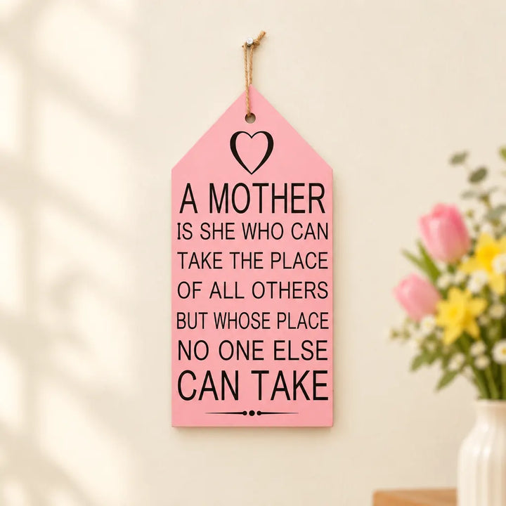 Pink tag-shaped wall caption decor plaque with A Mother quote and heart