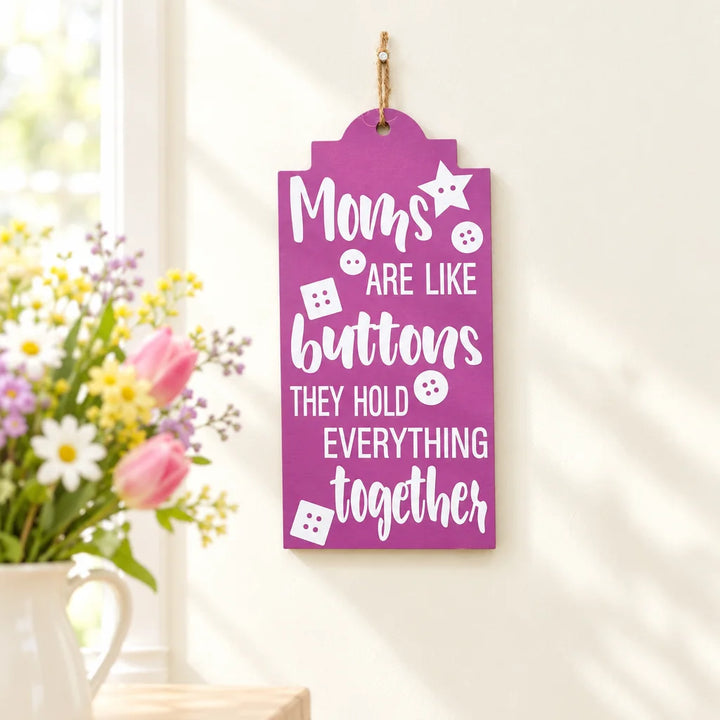 Purple tag-shaped wall caption decor with Moms are like buttons quote and flowers