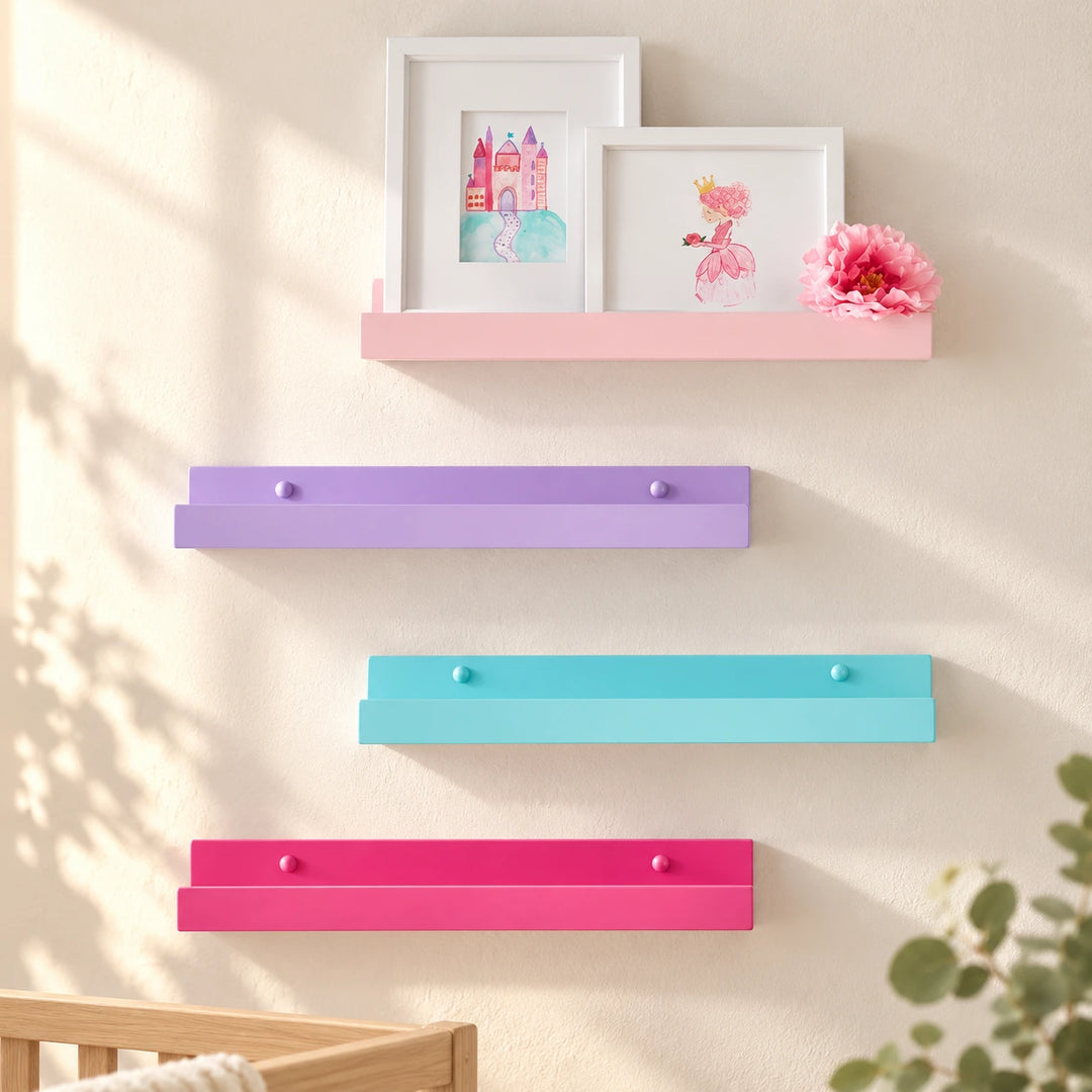 Pink, lavender, aqua and bright pink picture ledges styled on a naturally lit nursery wall