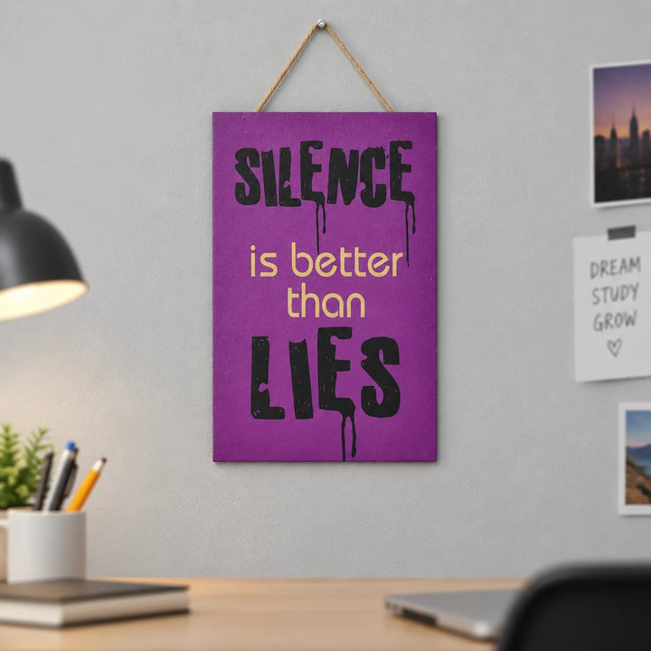 Purple Silence caption wall decor plaque hanging on grey wall above study desk