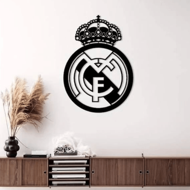 Real Madrid crest black wall art above wooden sideboard