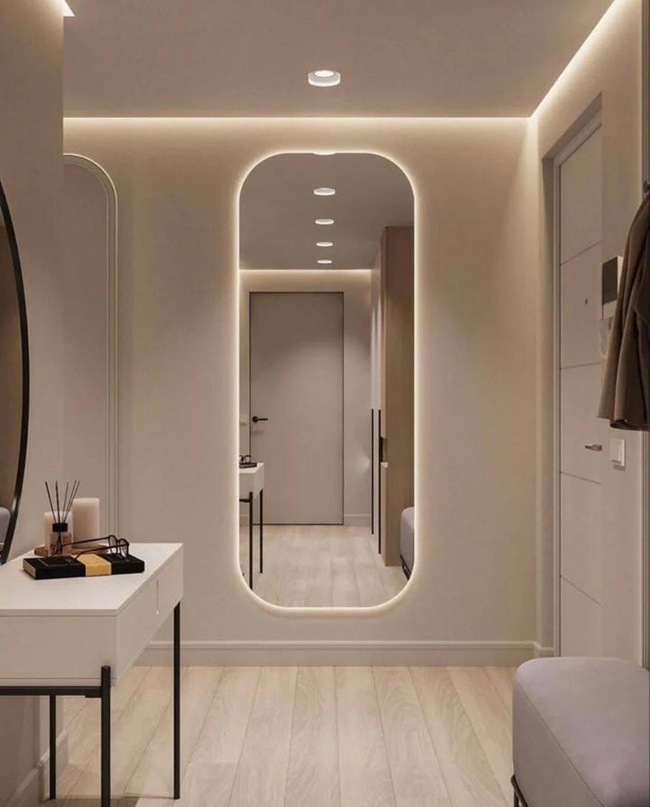Arched full length LED mirror with warm light in entryway dressing area