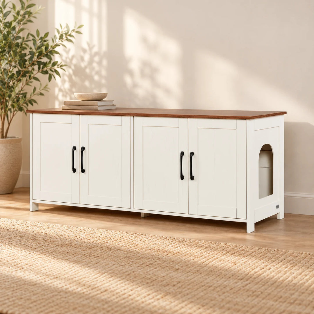 White four-door console with brown top and arched cat entrance in a styled living room with a natural plant