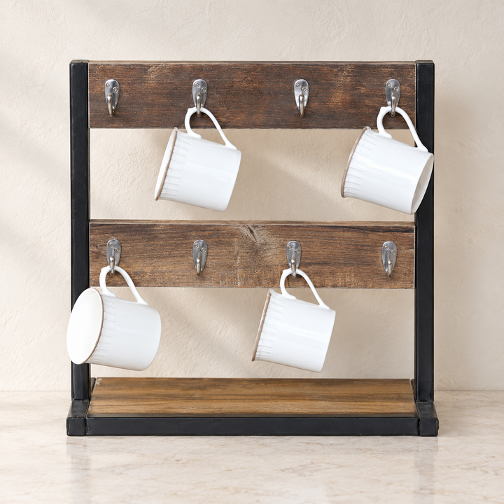 Rustic tea cup organizer rack with two brown rails, eight silver hooks and four white mugs against a neutral kitchen wall