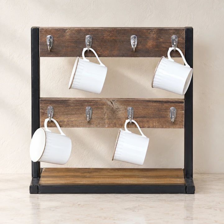 Rustic tea cup organizer rack with two brown rails, eight silver hooks and four white mugs against a neutral kitchen wall