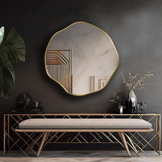 Scallo scalloped mirror with a gold-tone rim above an entryway console