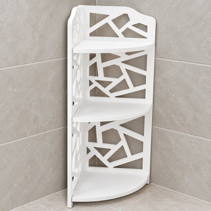 White three-tier PVC corner organizer with geometric cut-out sides in a softly lit tiled bathroom corner