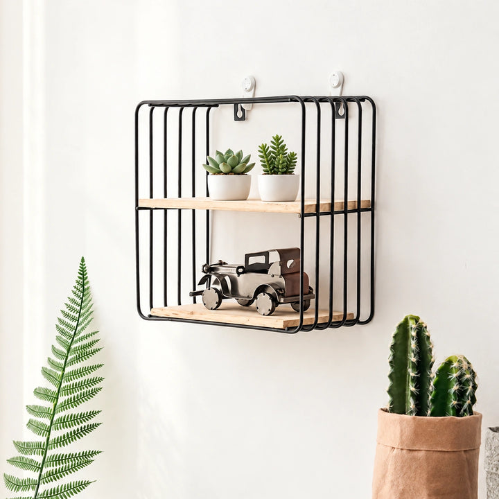 Black wire wall shelf with two natural wood tiers, small green plants and decorative vintage car