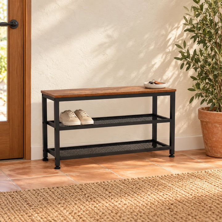 Shoe storage rack with brown top and two black mesh shelves styled in an entryway