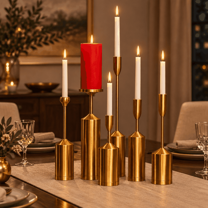 Six gold candle holders with red pillar and white taper candles on dining table