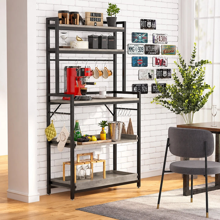 Slew grey five-tier bakers rack with black metal frame and coffee setup beside a dining chair