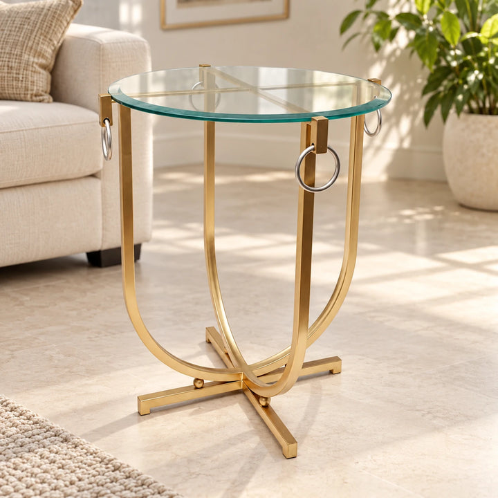Gold glass-top side table with hanging rings in a sunlit room