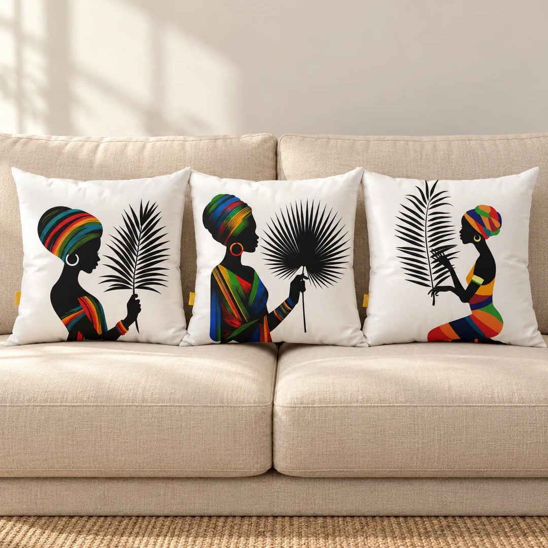 Three Soulfina cushion covers with their distinct printed portraits displayed on a neutral sofa