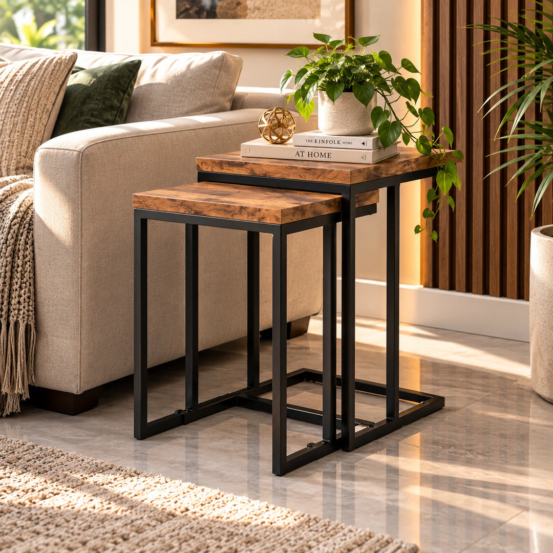 Two rectangular nesting side tables with brown tops and black frames beside a sofa