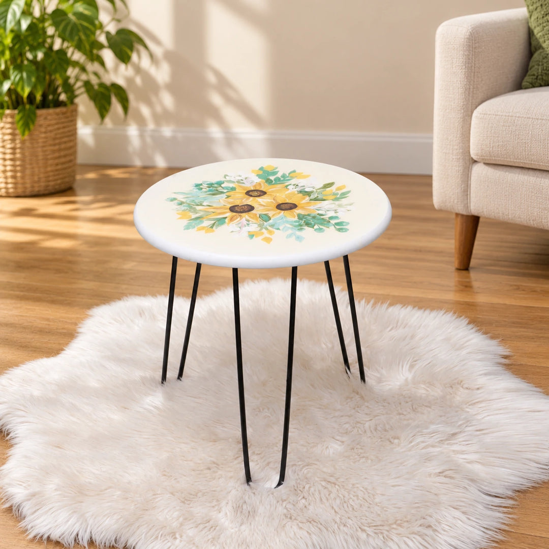 White sunflower-print round table with black hairpin legs in a naturally lit sitting room