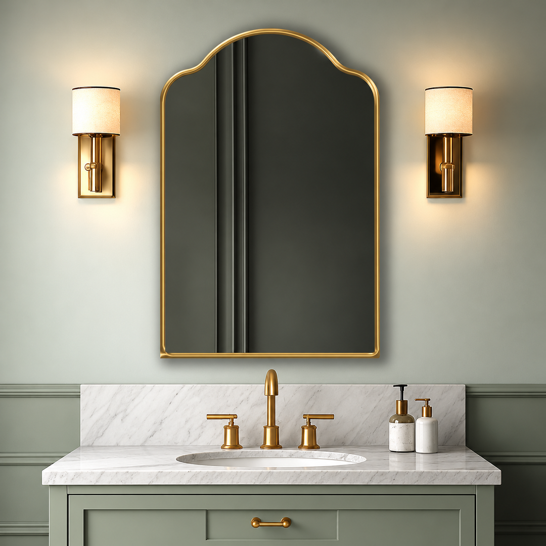 Single golden Sydney shaped-top mirror above a sage-green bathroom vanity, with the complete scalloped frame visible