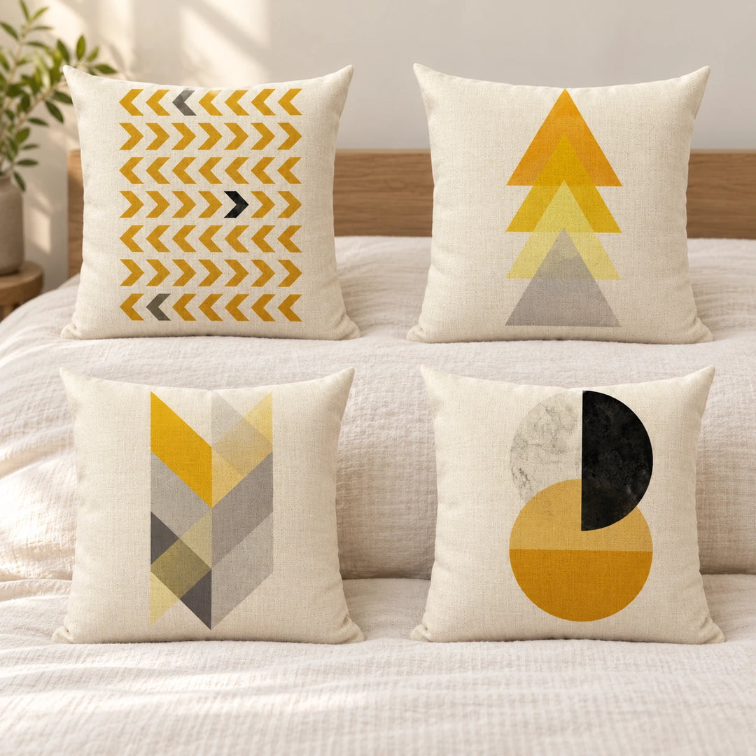 Four Tallasi cushion covers with yellow and grey geometric prints in daylight