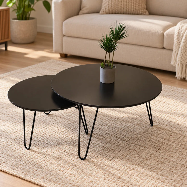 Set of two black Tatami round nesting hairpin tables in a neutral living room, preserving original relative sizes and potted plant; accessories for styling only