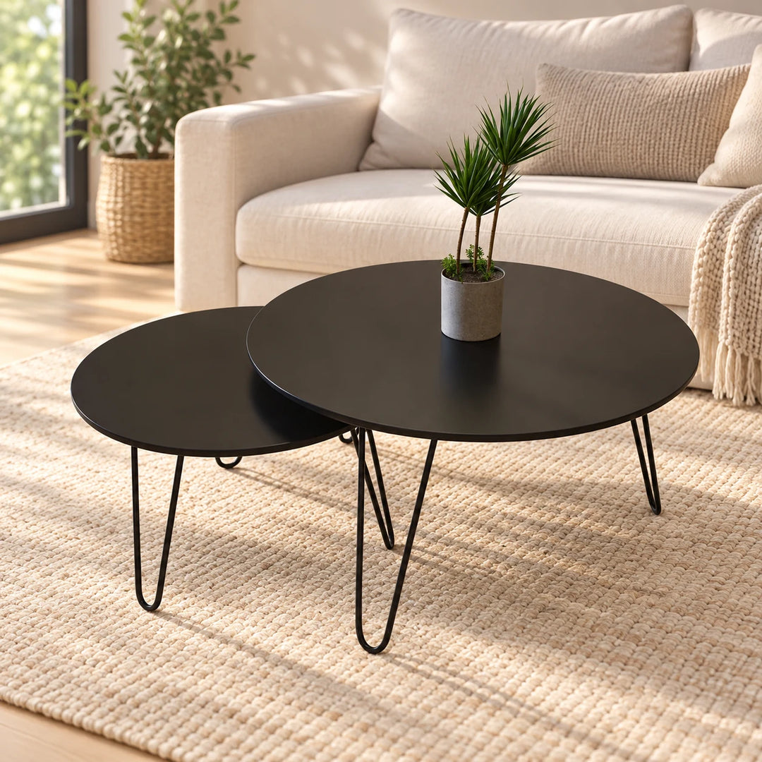 Tatami set of two black round nesting tables with black hairpin legs in a softly sunlit living room