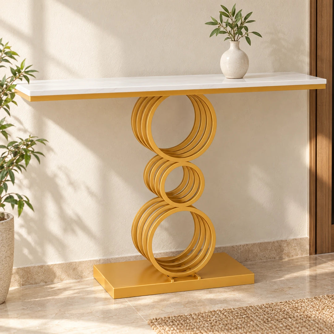 Ternary white console with three groups of four gold powder-coated rings in a sunlit entryway