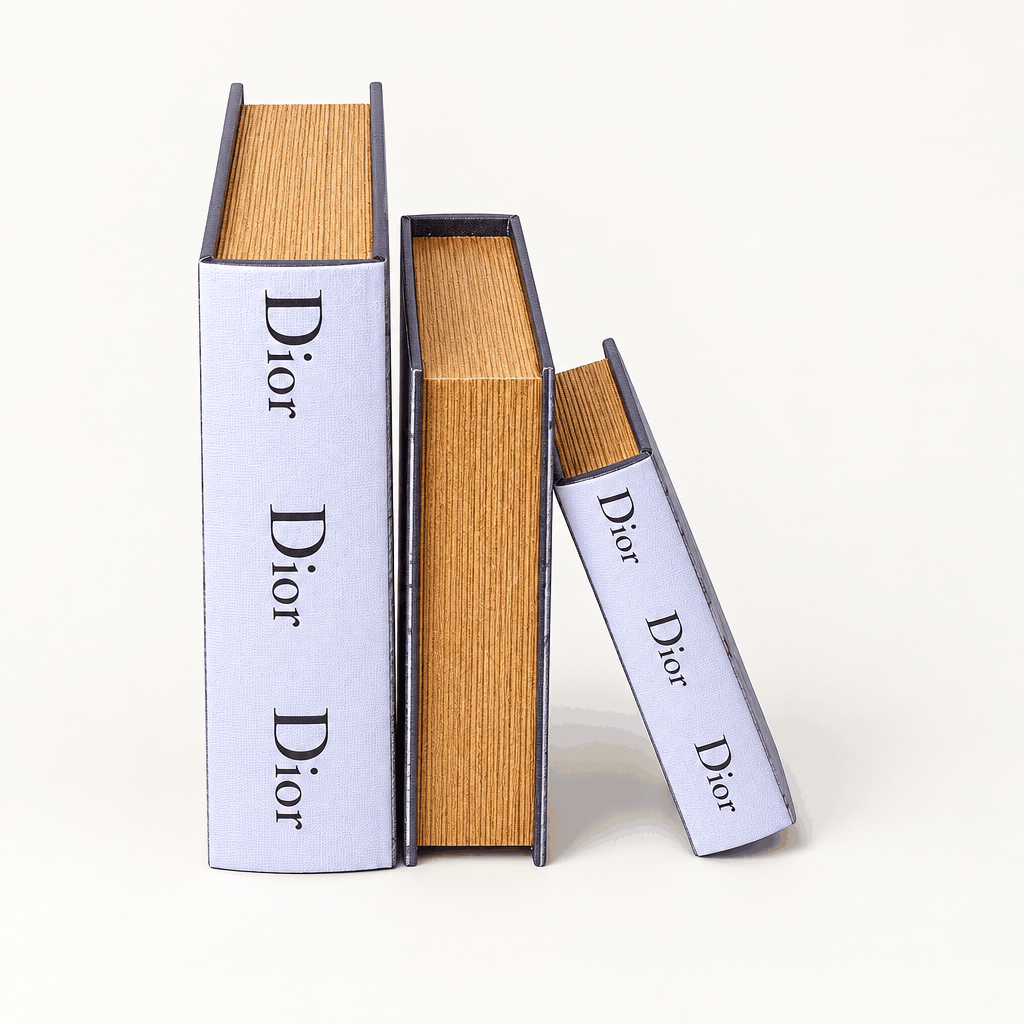 Set of three white book decor boxes in graduated sizes, upright on white background