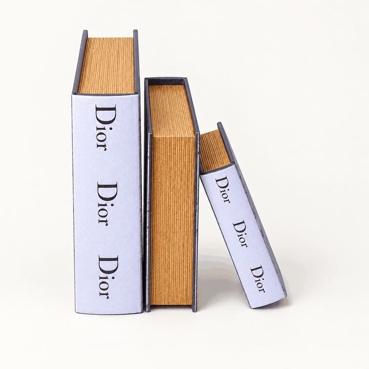 Set of three white book decor boxes in graduated sizes, upright on white background
