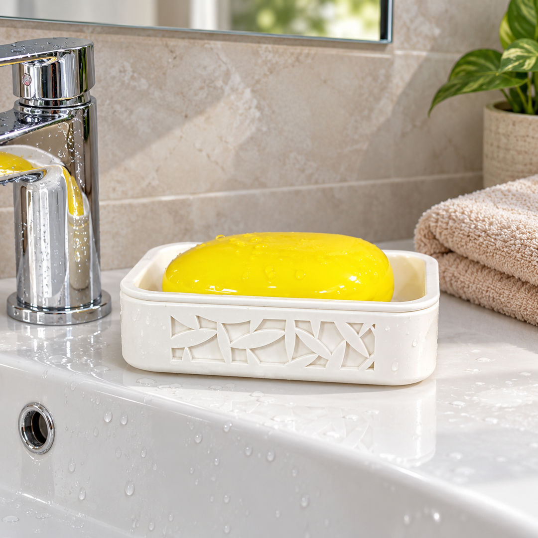 White traditional soap rack holding yellow soap beside a bathroom faucet and hand towel