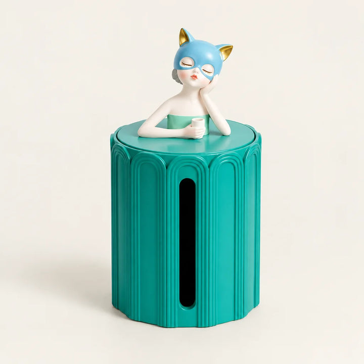 Green cylindrical figurine tissue box with blue haired girl on top, plain background