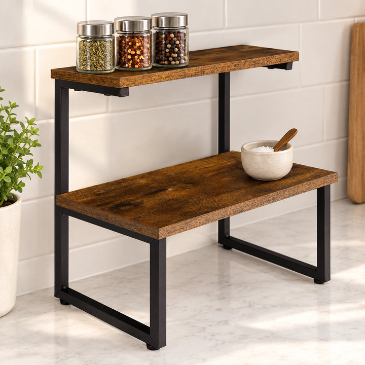 Rustic-brown two-tier spice organizer with black metal frame against a kitchen backsplash, holding spice jars and a salt cellar